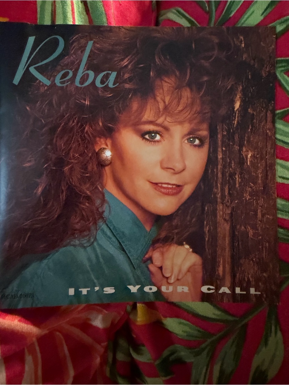 Reba Teal Jacket Album Cover with Brown Wood Background